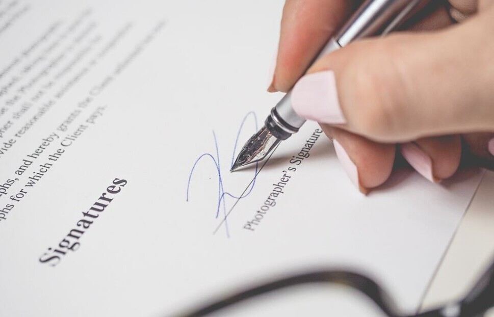 Woman Signing with pen